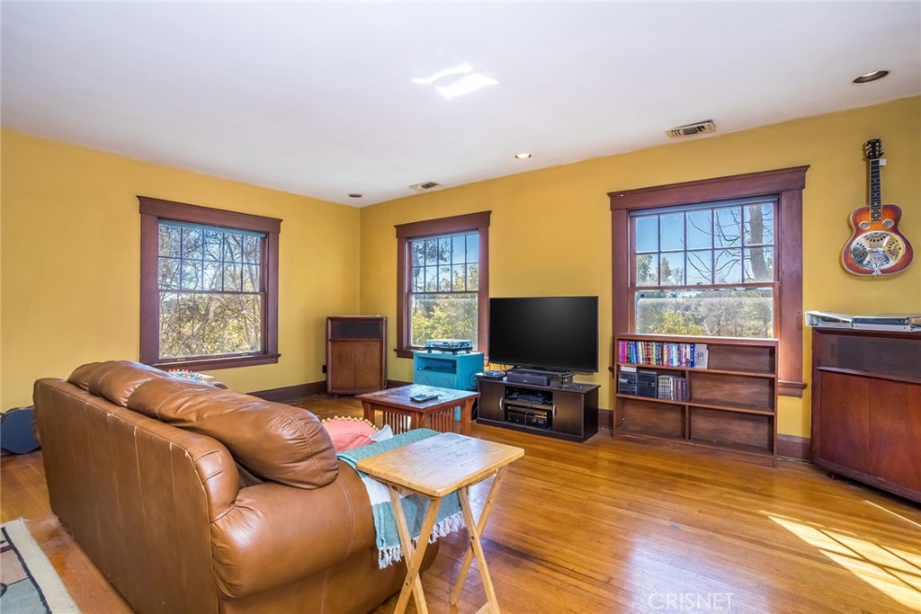 5289 Ellenwood Drive Eagle Rock, CA 90041 - Photo 25 of 28 a living room with furniture a flat screen tv and wooden floor