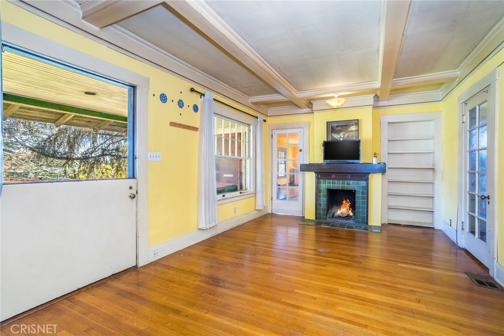 5289 Ellenwood Drive Eagle Rock, CA 90041 - Photo 6 of 28 a view of an empty room with wooden floor fireplace and a window