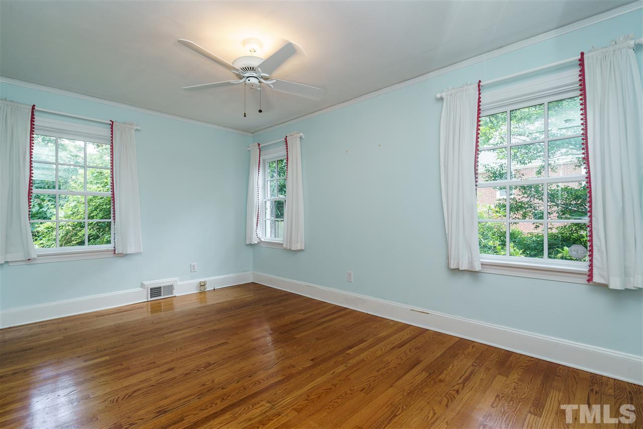 512 Burton Street Raleigh, NC 27608 - Photo 19 of 24 a view of an empty room with wooden floor and a window