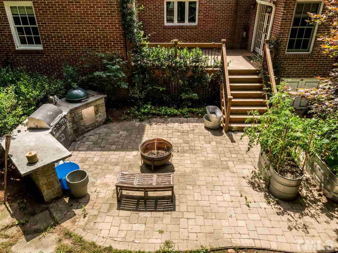 512 Burton Street Raleigh, NC 27608 - Photo 22 of 24 a view of a backyard with chair and potted plants