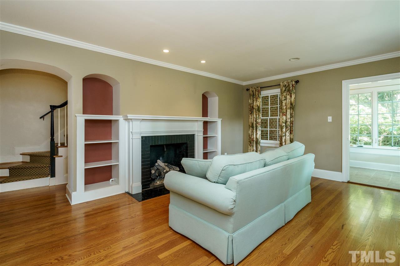 512 Burton Street Raleigh, NC 27608 - Photo 6 of 24 a living room with furniture and a fireplace