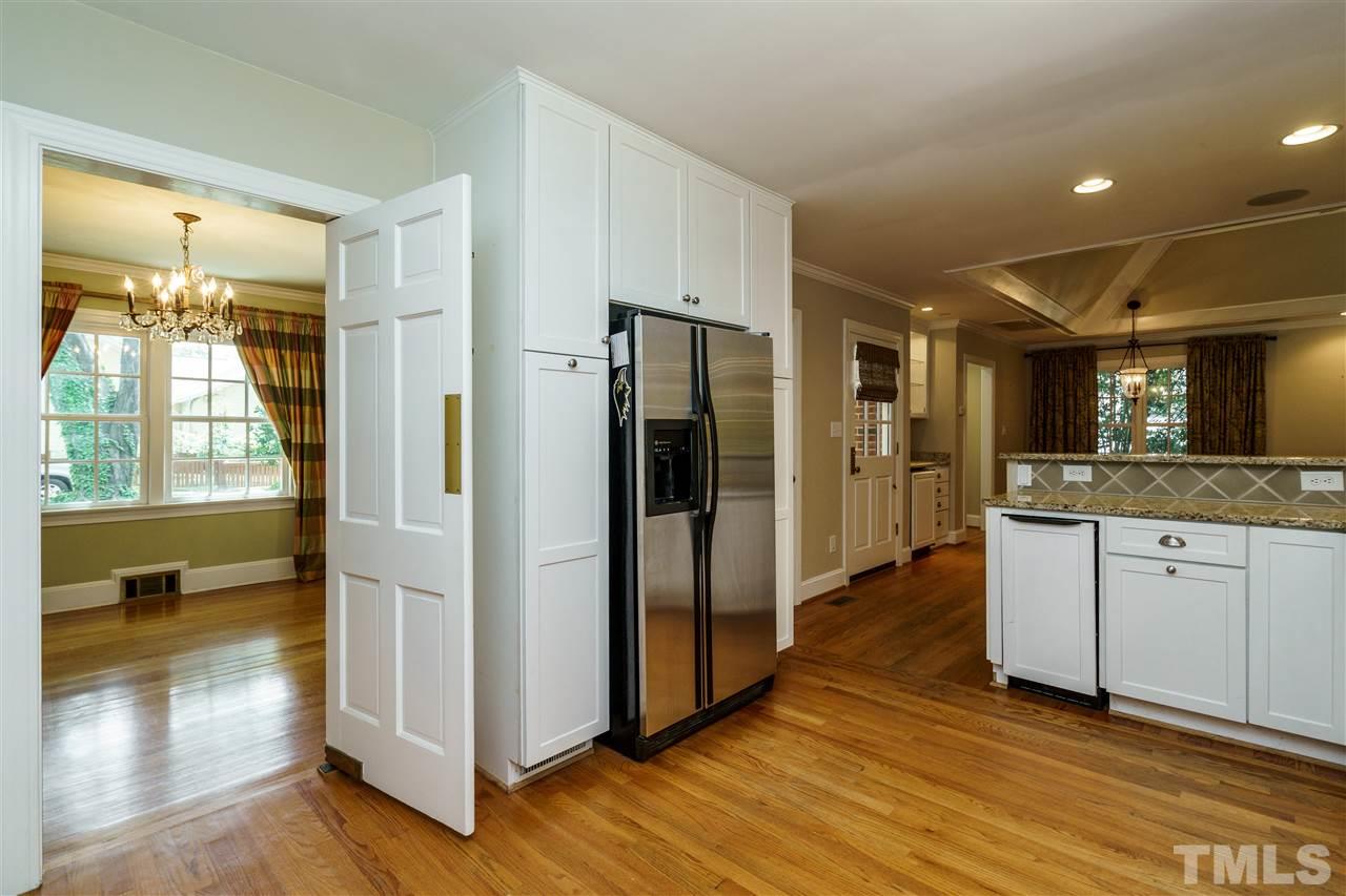 512 Burton Street Raleigh, NC 27608 - Photo 10 of 24 a view of a kitchen with refrigerator and wooden floor