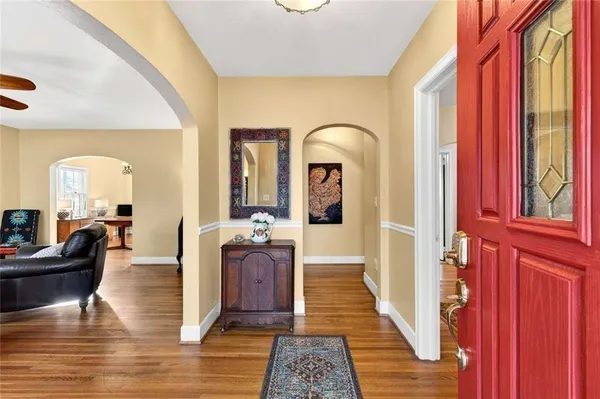 a living room with fireplace furniture and a wooden floor