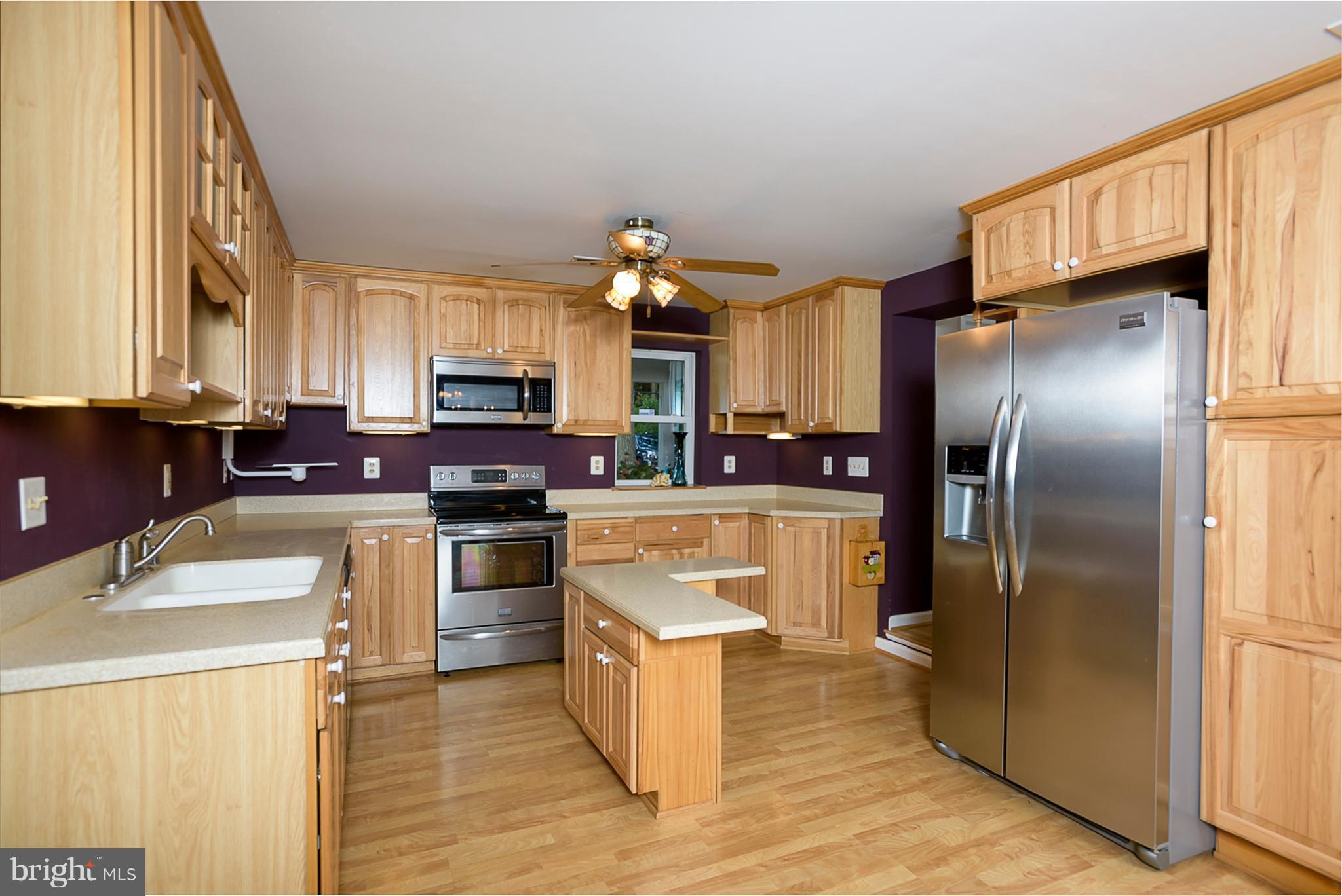 8216 Riverside Drive Pasadena, MD 21122 - Photo 8 of 30 Hickory cabinetry with stainless steel appliances