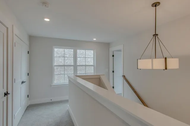 a living room with a couch and chandelier
