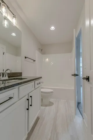 a bathroom with a sink a toilet and tub