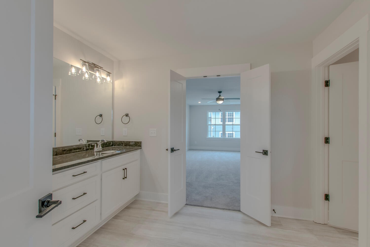 224 Tyler Cornerstone Trail Smyrna, TN 37167 - Photo 30 of 43 a spacious bathroom with a granite countertop sink a mirror and a shower
