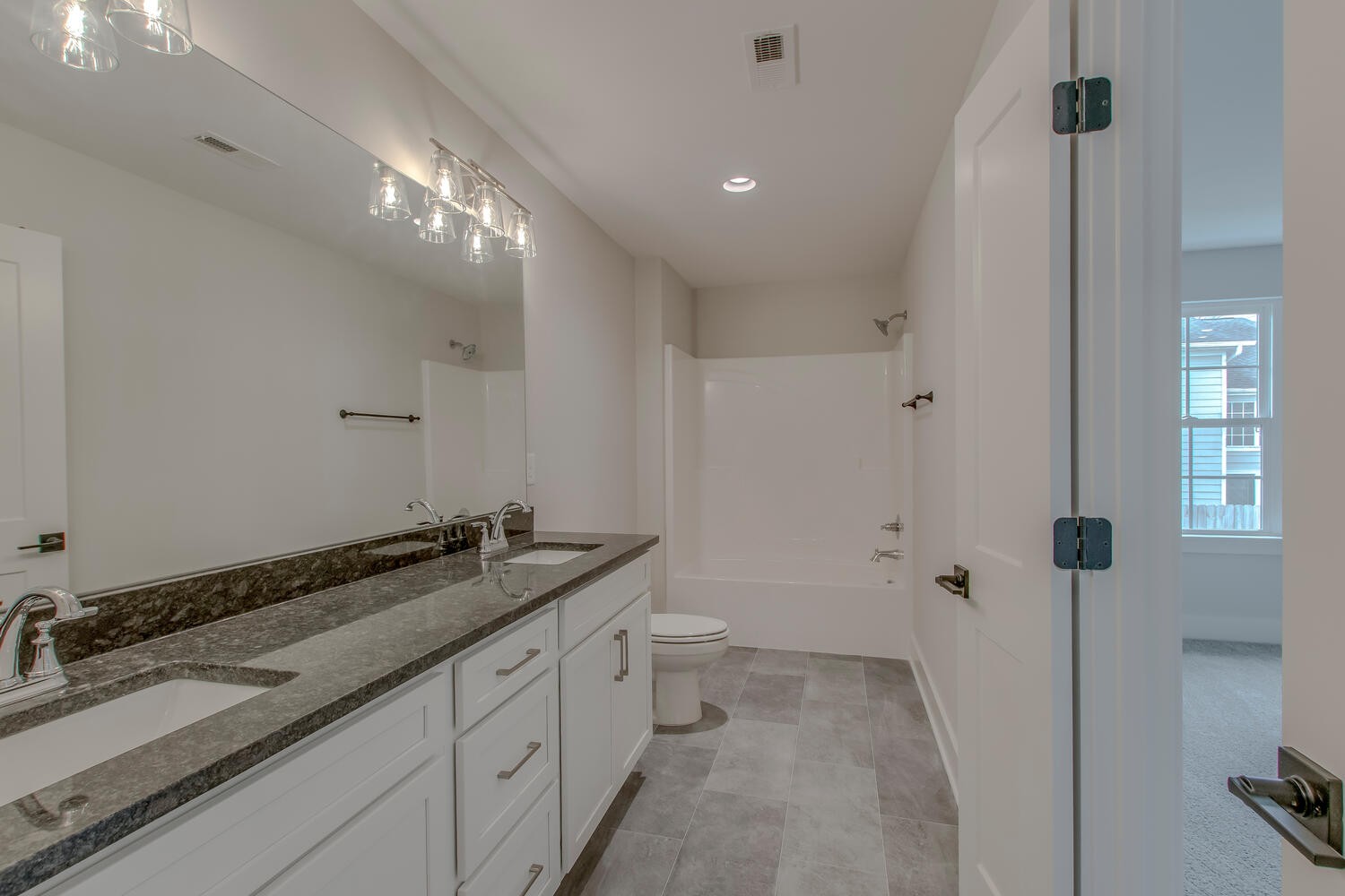 224 Tyler Cornerstone Trail Smyrna, TN 37167 - Photo 38 of 43 a spacious bathroom with a granite countertop sink a toilet a mirror and shower