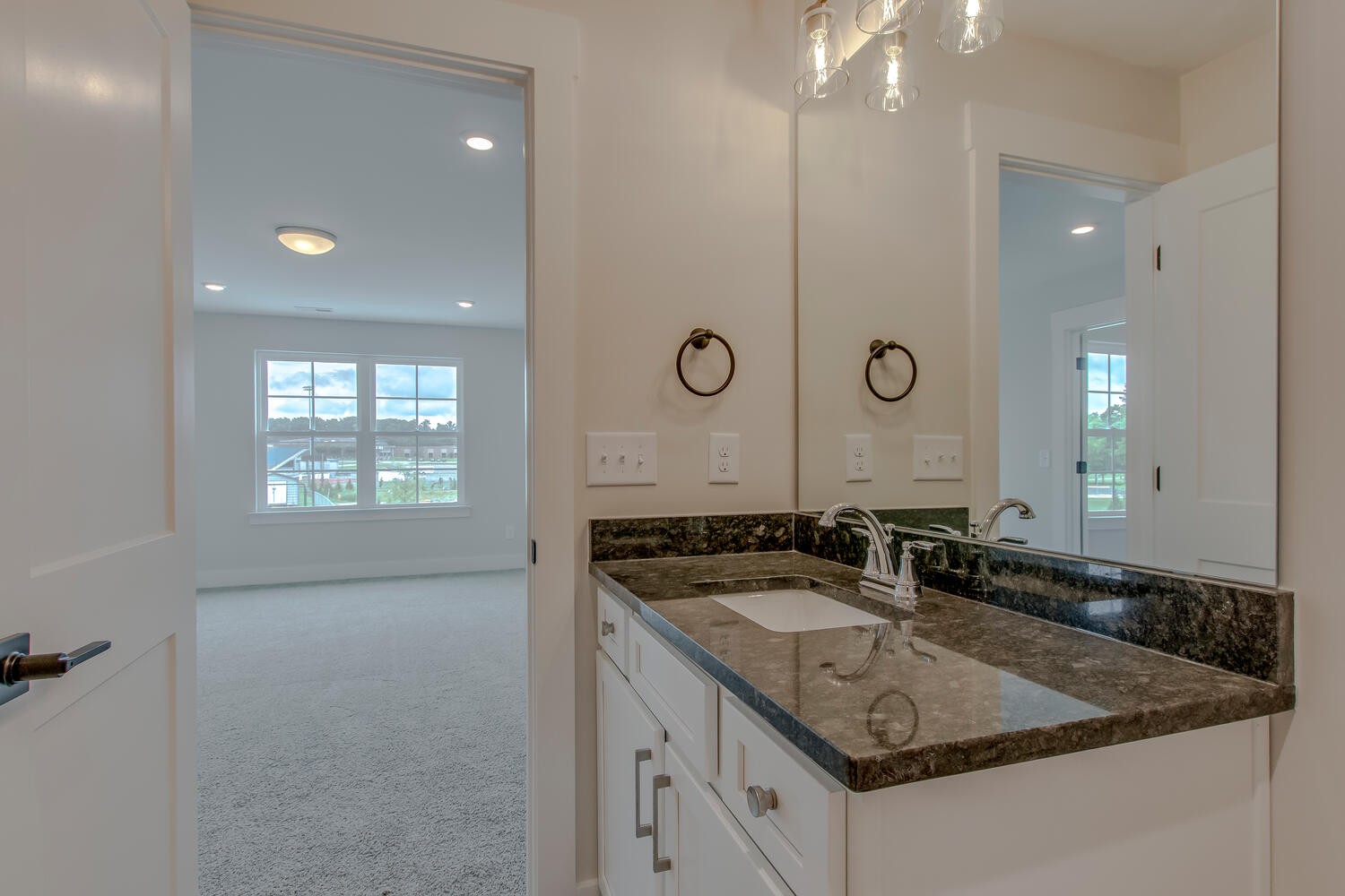 224 Tyler Cornerstone Trail Smyrna, TN 37167 - Photo 42 of 43 a bathroom with a granite countertop sink a mirror and a shower