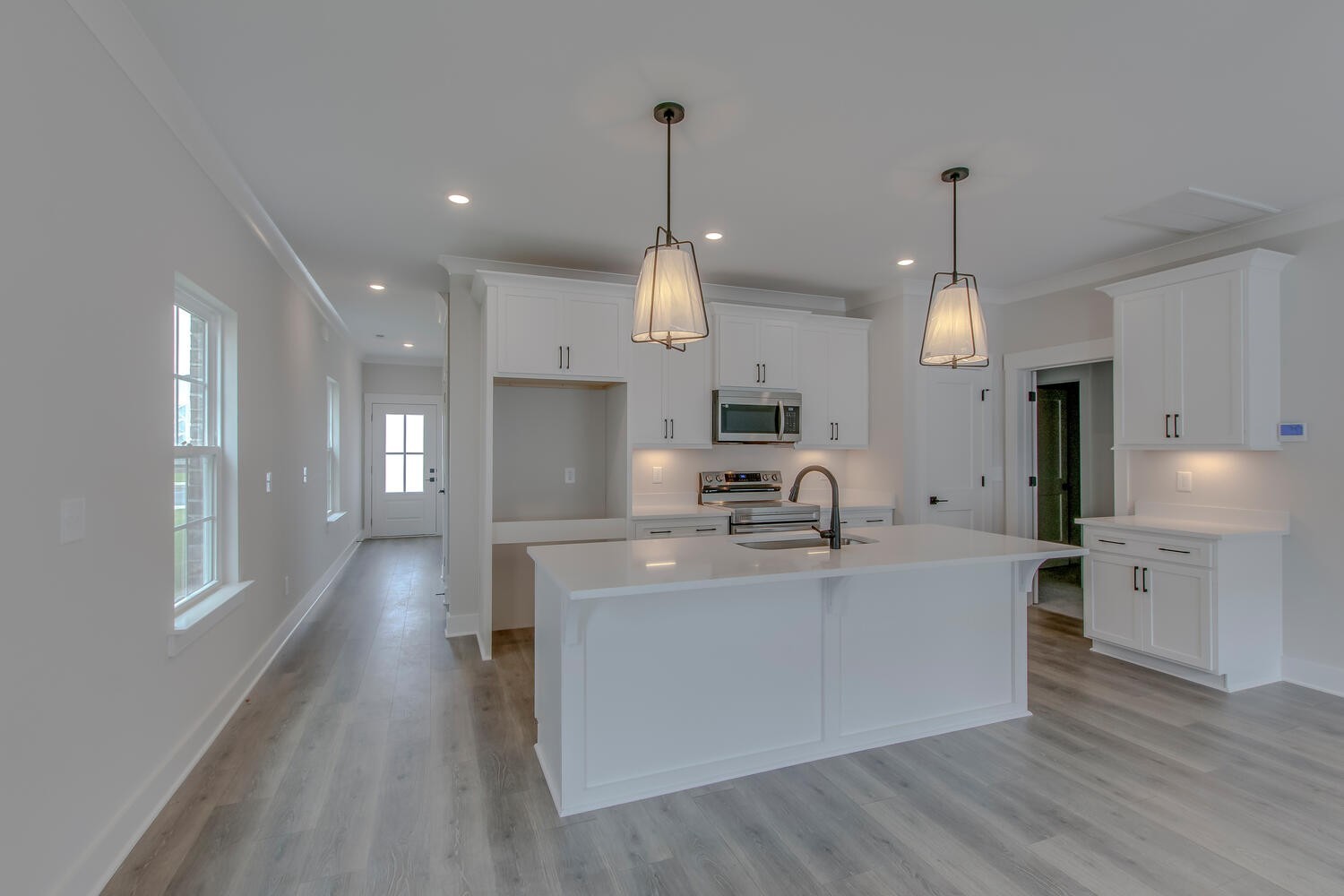 224 Tyler Cornerstone Trail Smyrna, TN 37167 - Photo 7 of 43 a large kitchen with stainless steel appliances kitchen island a large counter top and a wooden floors