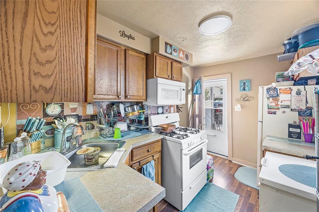 1136 Taggart Street McKees Rocks, PA 15136 - Photo 5 of 10 a kitchen with stainless steel appliances a stove a sink and a refrigerator