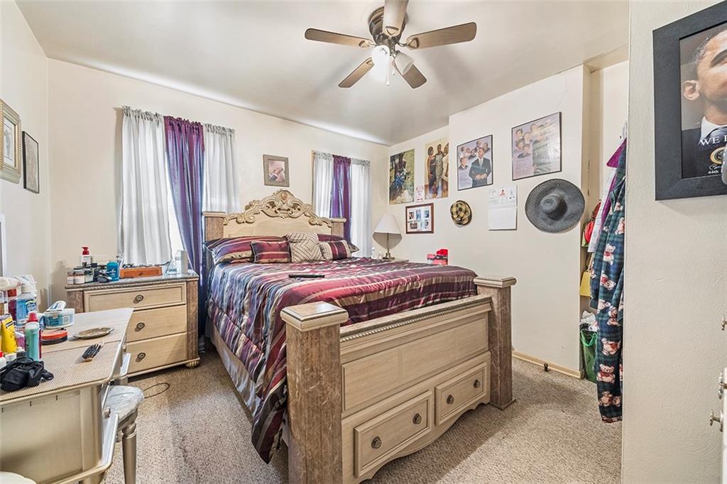 1136 Taggart Street McKees Rocks, PA 15136 - Photo 6 of 10 a bed room with a bed and a chandelier