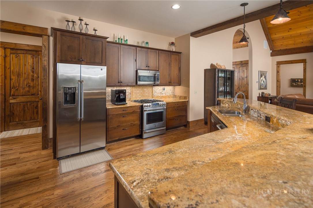 115 Passionflower Trail Boone, NC 28607 - Photo 6 of 50 a kitchen with granite countertop a refrigerator and a sink