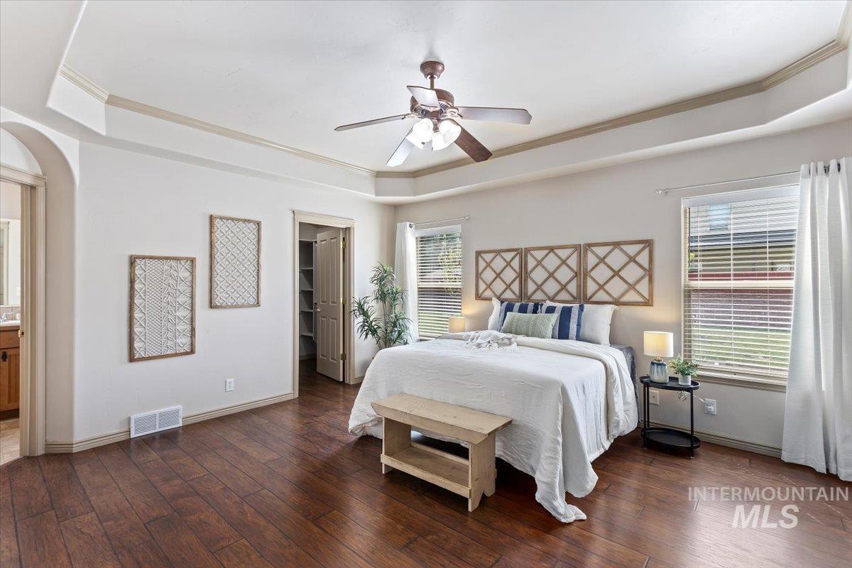 2274 Eastwood Road Twin Falls, ID 83301 - Photo 15 of 38 Spacious bedroom featuring wood-finish flooring, a tray ceiling with a ceiling fan, and two large windows with blinds