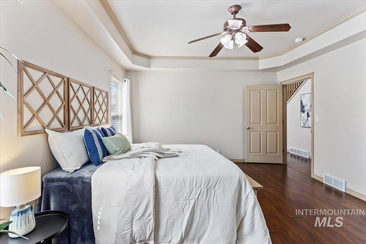 2274 Eastwood Road Twin Falls, ID 83301 - Photo 16 of 38 Bedroom featuring rich wood-finish flooring and a tray ceiling with a ceiling fan