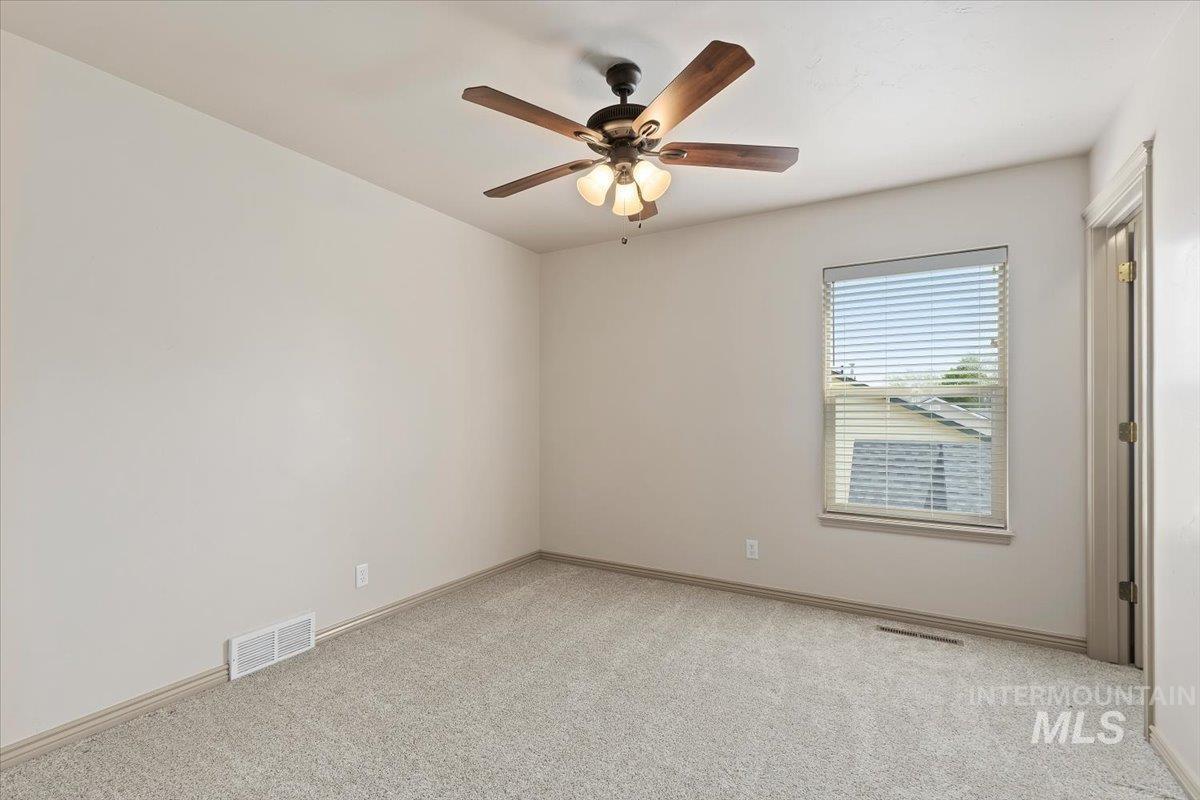 2274 Eastwood Road Twin Falls, ID 83301 - Photo 22 of 38 Carpeted room featuring a ceiling fan with light fixture, a window with blinds, and white baseboards