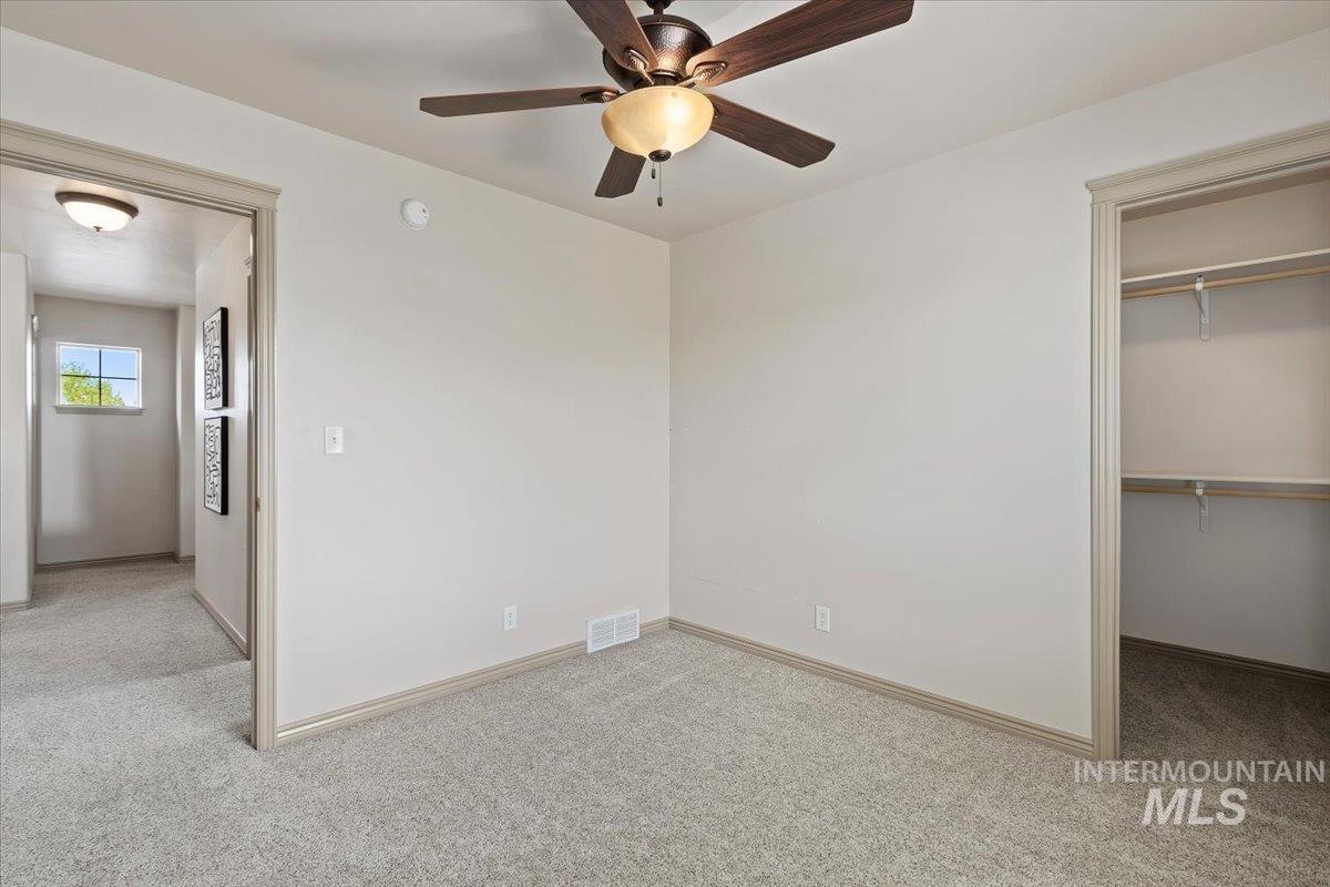 2274 Eastwood Road Twin Falls, ID 83301 - Photo 24 of 38 Carpeted interior space featuring a ceiling fan with integrated lighting, a built-in closet with shelving, and baseboard trim