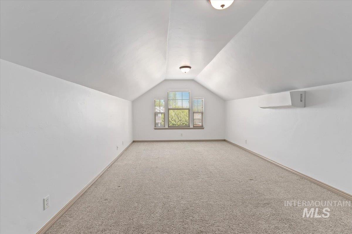 2274 Eastwood Road Twin Falls, ID 83301 - Photo 26 of 38 Spacious bonus room featuring vaulted ceilings, neutral carpeting, a triple window dormer, and recessed lighting