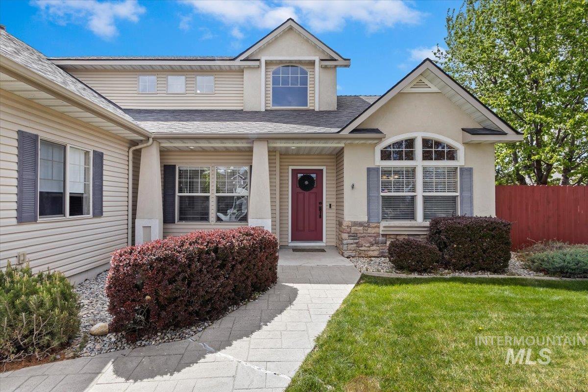 2274 Eastwood Road Twin Falls, ID 83301 - Photo 3 of 38 Exterior featuring a covered entryway, a red front door with an arched transom, and stone veneer accents
