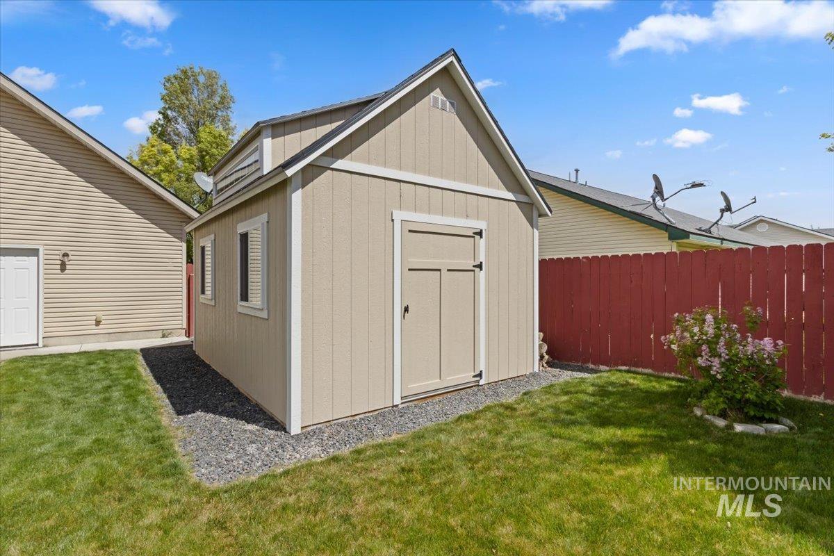 2274 Eastwood Road Twin Falls, ID 83301 - Photo 35 of 38 Gable-roofed storage shed featuring double doors, two side windows with trim, and a raised roofline detail