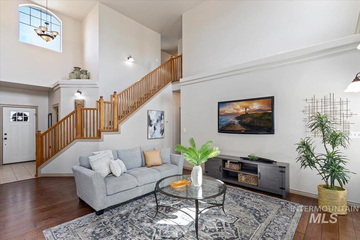 2274 Eastwood Road Twin Falls, ID 83301 - Photo 5 of 38 Spacious living area featuring high ceilings, wood-finish flooring, and a prominent staircase with wood banisters