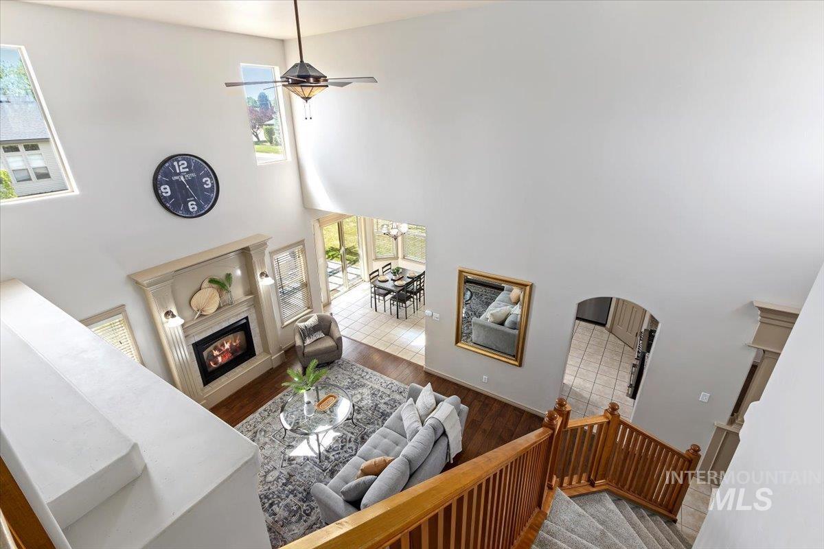 2274 Eastwood Road Twin Falls, ID 83301 - Photo 6 of 38 Vaulted ceiling living area featuring a fireplace with a detailed mantel, wood-finish flooring, and natural light from upper windows