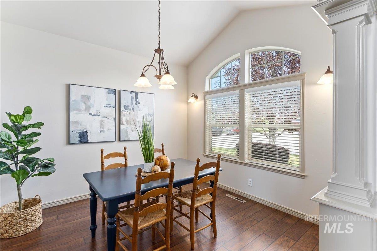 2274 Eastwood Road Twin Falls, ID 83301 - Photo 8 of 38 Dining area featuring vaulted ceilings, wood-finish flooring, and a decorative column