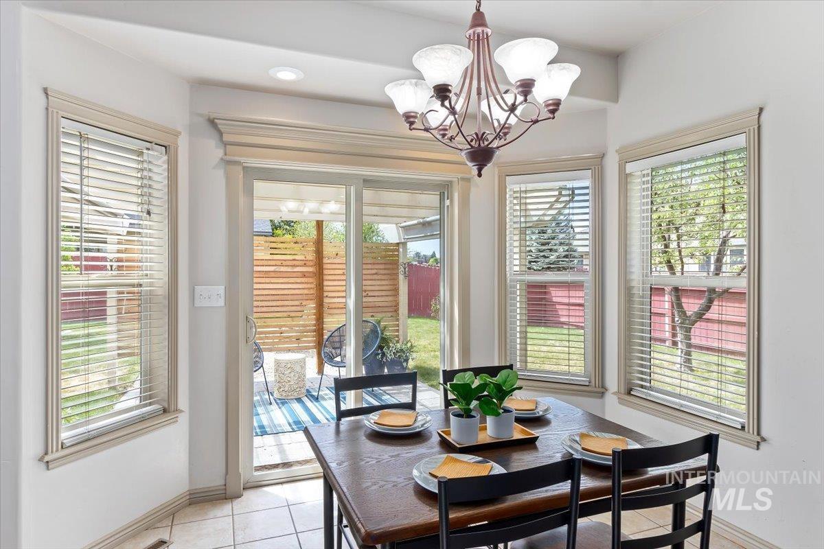 2274 Eastwood Road Twin Falls, ID 83301 - Photo 10 of 38 Dining area with bay windows and a chandelier light fixture