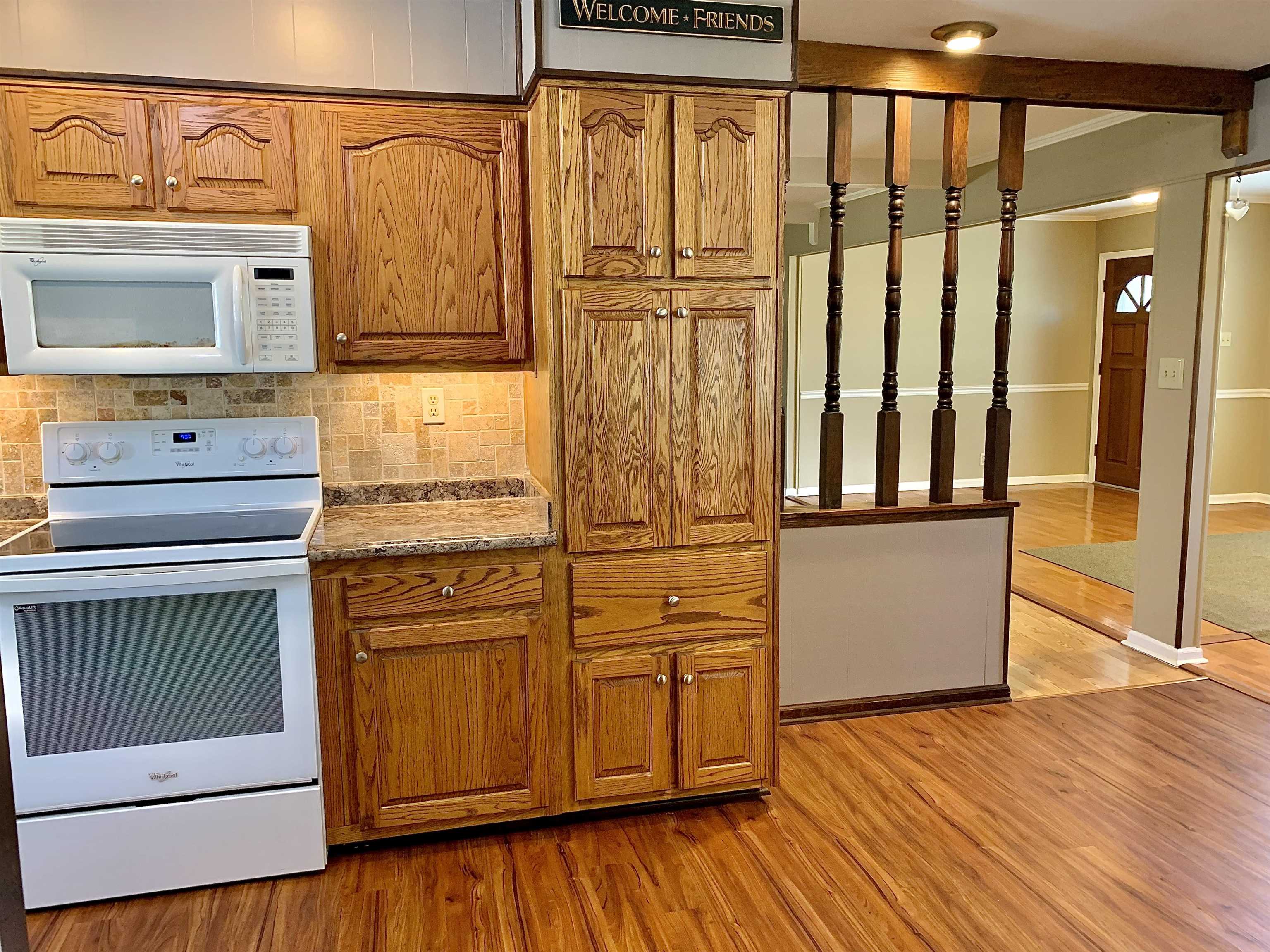 1815 Old Enon Road Middleton, TN 38052 - Photo 5 of 38 Kitchen with tasteful backsplash, white appliances, light hardwood / wood-style floors, and stone countertops