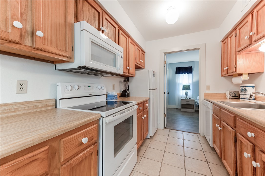622 Beach Access Road, Unit 225 Port Aransas, TX 78373 - Photo 14 of 21 a kitchen with stainless steel appliances granite countertop a stove and a sink