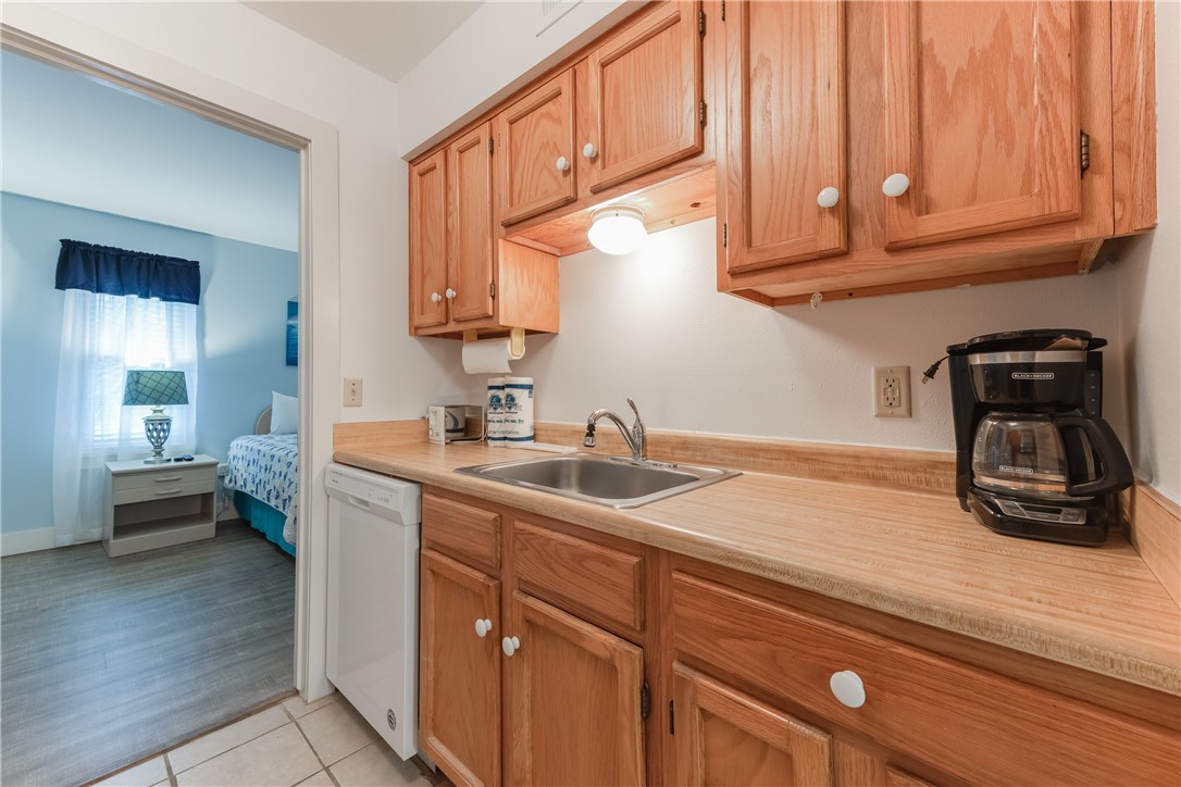 622 Beach Access Road, Unit 225 Port Aransas, TX 78373 - Photo 15 of 21 a kitchen with sink cabinets and stove