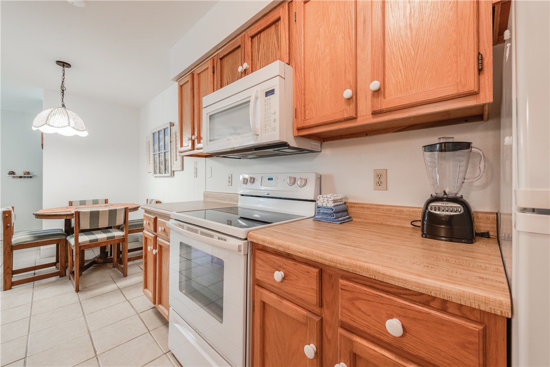 622 Beach Access Road, Unit 225 Port Aransas, TX 78373 - Photo 16 of 21 a kitchen with stainless steel appliances granite countertop a sink and cabinets