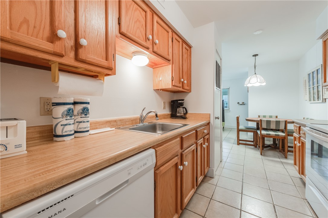 622 Beach Access Road, Unit 225 Port Aransas, TX 78373 - Photo 17 of 21 a kitchen with a sink and cabinets