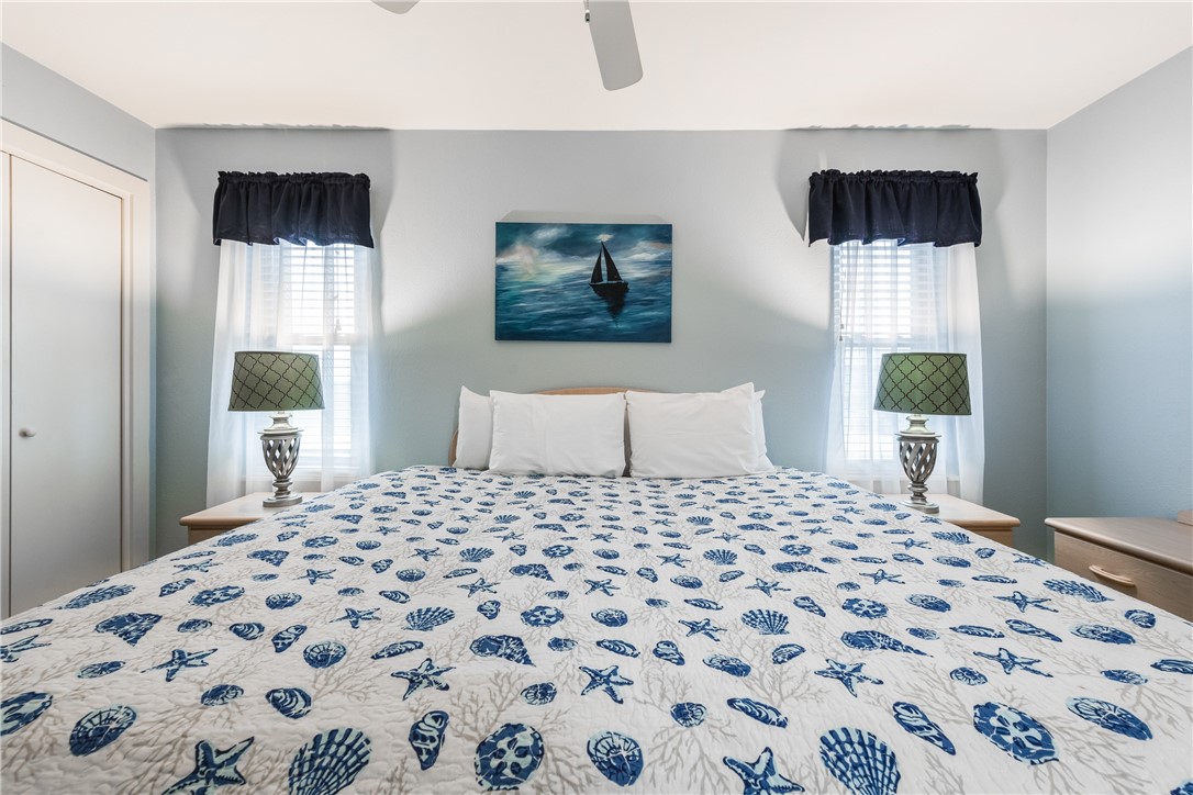 622 Beach Access Road, Unit 225 Port Aransas, TX 78373 - Photo 19 of 21 a bedroom with a bed and a window