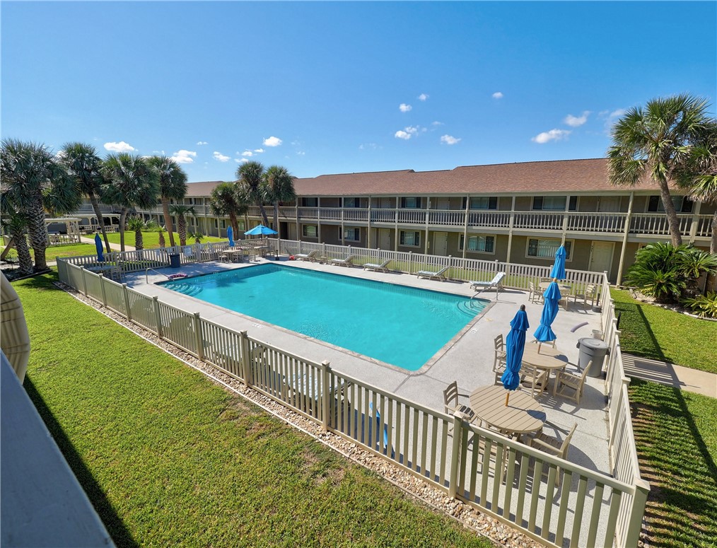622 Beach Access Road, Unit 225 Port Aransas, TX 78373 - Photo 7 of 21 a view of a house with a backyard patio and swimming pool