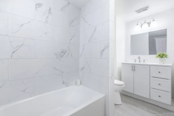 a bathroom with a sink a toilet and bathtub