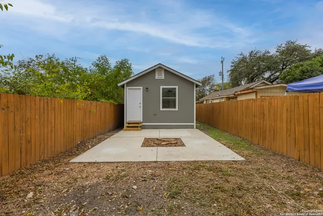 a view of backyard of house with trees