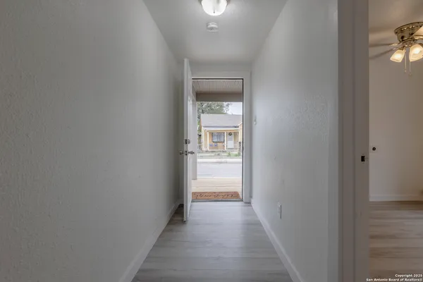 a view of a hallway with a white walls