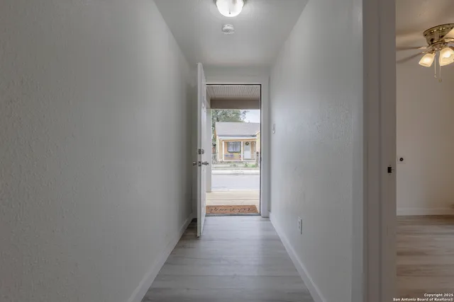 a view of a hallway with a white walls