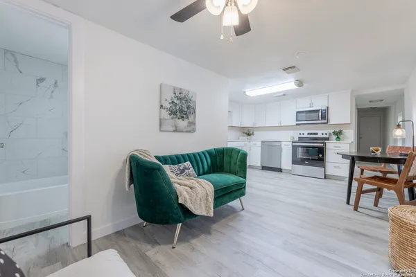 a living room with furniture kitchen view and a fireplace