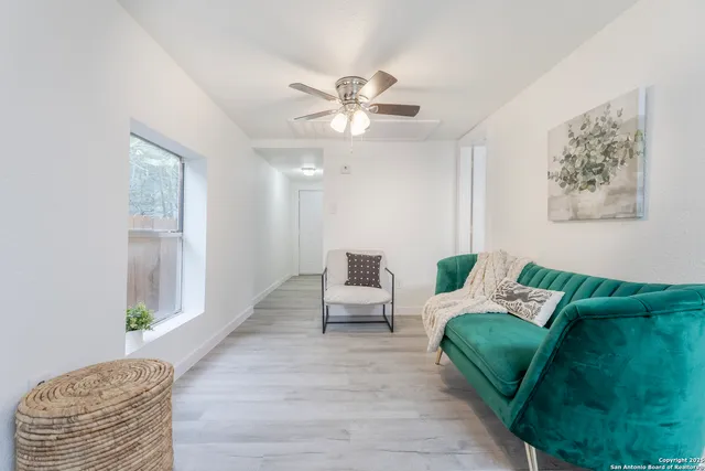 a living room with furniture and a chandelier