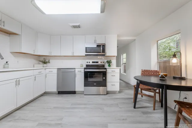 a kitchen with a stove a sink and a refrigerator
