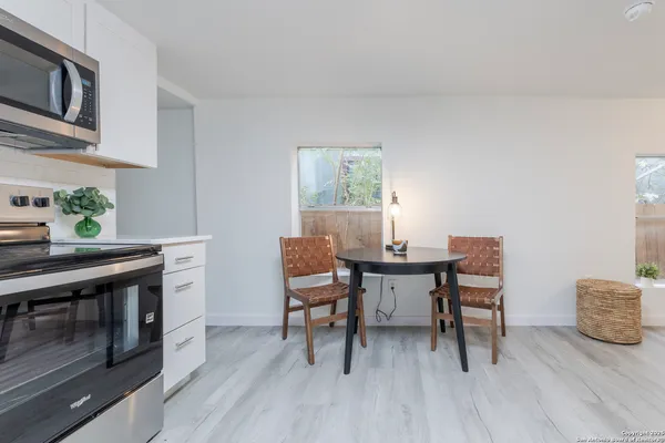 a view of a workspace with furniture and a kitchen