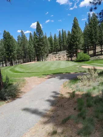 a view of a golf course with a house