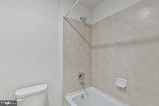 a bathroom with a toilet and bathtub