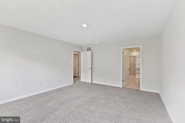 a view of an empty room and closet area