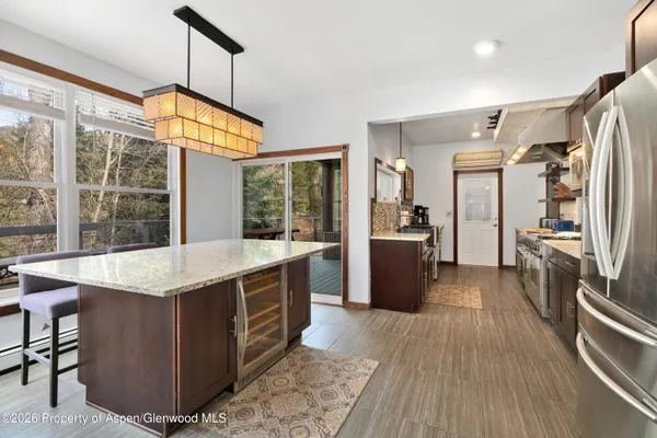 a kitchen with stainless steel appliances granite countertop a stove and refrigerator