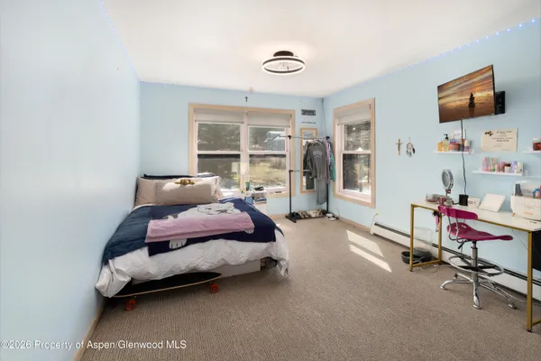 a bedroom with furniture and a window