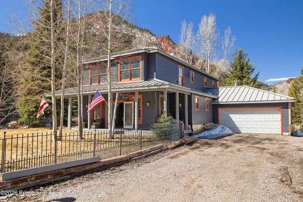 a view of a house with wooden fence