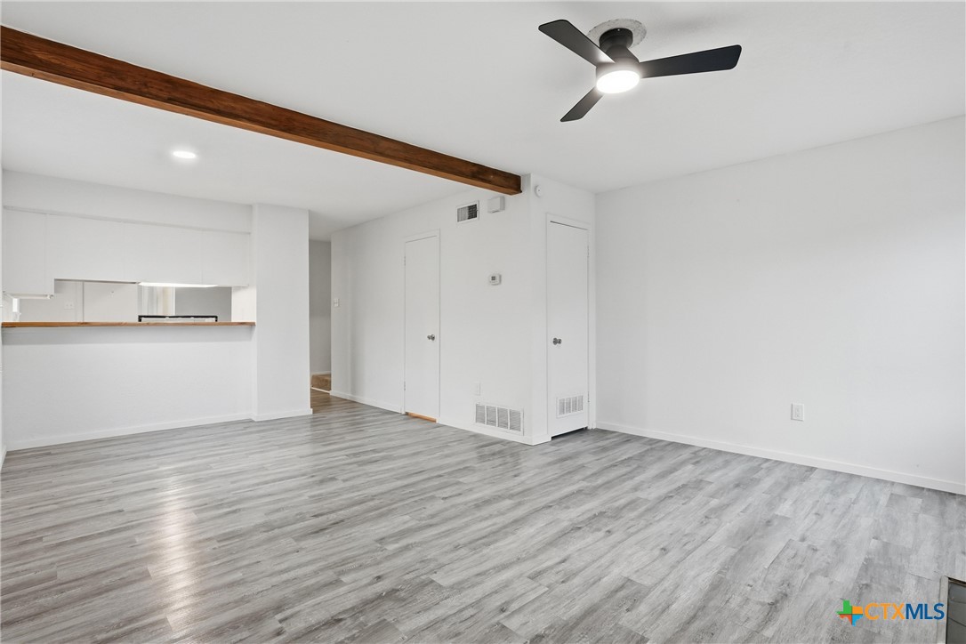 922 North 7th Street Copperas Cove, TX 76522 - Photo 5 of 26 a view of a kitchen with wooden floor and a ceiling fan